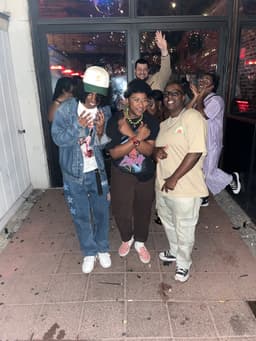 kidd poses with her masc friends, azzie and dom, in the outdoor area of a brooklyn nightclub