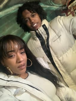 kidd poses for a nighttime selfie with friend and fellow artist, Mkae Ultra. they both wear white/off-white bubble jackets